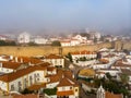 Scenic view of white houses red tiled roofs, and castle from wall of fortress with clouds. Obidos village, Portugal. Royalty Free Stock Photo