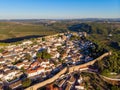 Scenic view of white houses red tiled roofs, and castle from wall of fortress. Obidos village, Portugal. Royalty Free Stock Photo