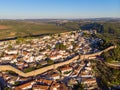 Scenic view of white houses red tiled roofs, and castle from wall of fortress. Obidos village, Portugal. Royalty Free Stock Photo