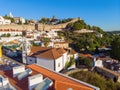 Scenic view of white houses red tiled roofs, and castle from wall of fortress. Obidos village, Portugal. Royalty Free Stock Photo