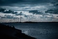 Scenic view of wind turbines at an offshore wind farm near the coast on cloudy day at dusk Royalty Free Stock Photo