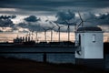 Scenic view of wind turbines at an offshore wind farm near the coast on cloudy day at dusk Royalty Free Stock Photo