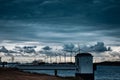 Scenic view of wind turbines at an offshore wind farm near the coast on cloudy day at dusk Royalty Free Stock Photo