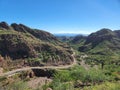 Scenic view of a winding desert road, framed by majestic mountain peaks Royalty Free Stock Photo