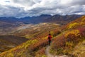 Scenic View of Woman Hiking on a Cloudy Fall Day