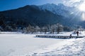 Scenic view on wonderful frozen lake jasna with footbridge in julian alps in blue sky, kranjska gora, Slovenia