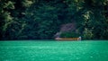 Scenic view of a wooden boat moored at the bank of the Rhein river against greenery in Switzerland Royalty Free Stock Photo