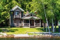 Scenic view of a wooden cottage on the shore of the lake Raquette in Adirondacks, USA Royalty Free Stock Photo