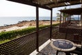 Scenic view of a wooden porch on the beach with palm trees on a sunny day Royalty Free Stock Photo