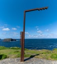 Scenic viewpoint at the Kilkee Cliffs on the Wild Atlantic Way in western Ireland with the typical signpost