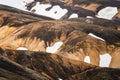 Scenic of volcanic mountain with snow covered and hiker walking on the ridge in Fjallabak nature reserve on Icelandic highlands at