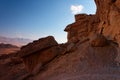 Scenic weathered orange rock in stone desert on su