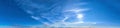 Scenic wide panorama of sunny summer sky in Northern Europe, Scandinavia. Sweden. Sun rays on blue sky with cirrus clouds Royalty Free Stock Photo