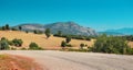 Winding Asphalt road with a view of a lonely rocky mountain in the countryside area in Turkey Royalty Free Stock Photo