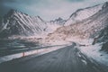 Scenic winter road through the snowy rocky mountains to the village Vikten on the atlantic shore, Lofoten, Norway Royalty Free Stock Photo