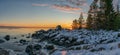 Scenic Winter Sunset Panorama Over Sea with Icy and Snowy coastline, very big stones, Northern Sweden, Kont, Baltic region. Close Royalty Free Stock Photo