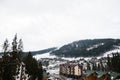 Scenic winter view of ski resort with house and cottage in Bukovel, Carpathian Mountains, Ukraine