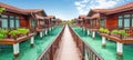 Scenic wooden walkway leading to overwater bungalows above turquoise ocean at tropical resort
