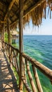 Scenic wooden walkway over turquoise ocean to overwater bungalows at tropical resort