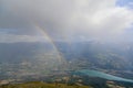 A scenics view of a mountain summit with a majestic double rainbow and Embrun, Hautes-alpes, France in the background under a
