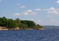 Scenis view of blue river bay, trees and sky