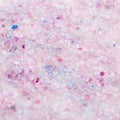 Scented bath salt closeup background in pink and purple colors, top view Royalty Free Stock Photo