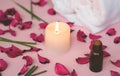 Scented candle and dry petals on pink background; wellness or sp Royalty Free Stock Photo