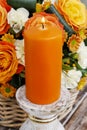 Scented candle in front of bouquet of flowers Royalty Free Stock Photo