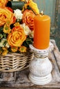 Scented candle in front of bouquet of flowers Royalty Free Stock Photo