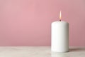Scented candle for relax on white table against pink background
