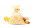 Scented sachet with aroma beads, cinnamon and dried orange slices on white background