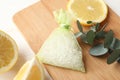 Scented sachet with aroma beads, eucalyptus branch and lemon on white wooden table, closeup