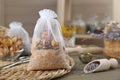 Scented sachet with dried roses on table