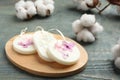 Scented sachets and cotton flowers on blue wooden table