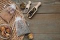 Scented sachets with dried flowers on wooden table, flat lay. Space for text Royalty Free Stock Photo