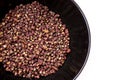 Scented Sichuan pepper in the black bowl on the white table isolated image. Sichuan pepper or Chinese pepper or Timur or Nepali