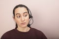 Sceptical help desk operator listening to a call Royalty Free Stock Photo