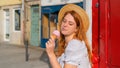 sceptical woman looking on ice cream outdoors