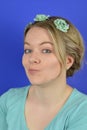 Sceptical young blond woman with flowers on a hair circlet Royalty Free Stock Photo