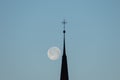 Full moon behind the holy cross of a church in Schaan in Liechtenstein Royalty Free Stock Photo