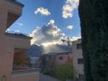 Schaan, Liechtenstein, October 21, 2021 Sun rays behind a cumulus cloud over the alps Royalty Free Stock Photo