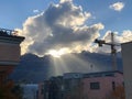 Schaan, Liechtenstein, October 21, 2021 Sun rays behind a cumulus cloud over the alps Royalty Free Stock Photo