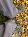 SCHAAN, LIECHTENSTEIN, SEPTEMBER 27, 2021 Feet on some dry leafs on the ground