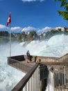 Tourists enjoying moments in scenic Rhine falls.