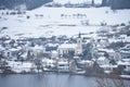 Schalkenmehren, Germany - 01 06 2021: Schalkenmehren, church and houses at the caldera lake