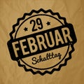 Schalttag 29 Februar Stempel German black on a crumpled paper brown background.