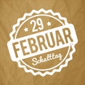 Schalttag 29 Februar Stempel German white on a crumpled paper brown background.