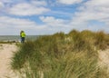 SCHARENDIJKE - NETHERLANDS -MAY, 17, 2018: active senior couple looking at North-Sea in dunes near of Netherlands