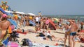 Schastlivtsevo, Ukraine - August 2, 2020: Many people on the beach, resting on the Sea of Azov. Crowded sunny beach