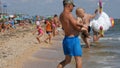 Schastlivtsevo, Ukraine - August 2, 2020: Many people on the beach, resting on the Sea of Azov. Crowded sunny beach